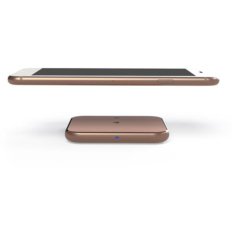 Phone hovering over Wireless charger ChargePad in rose gold